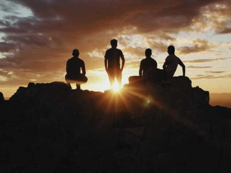 four tourists watch the sunset from a Wildlife Heritage Area for responsible travel