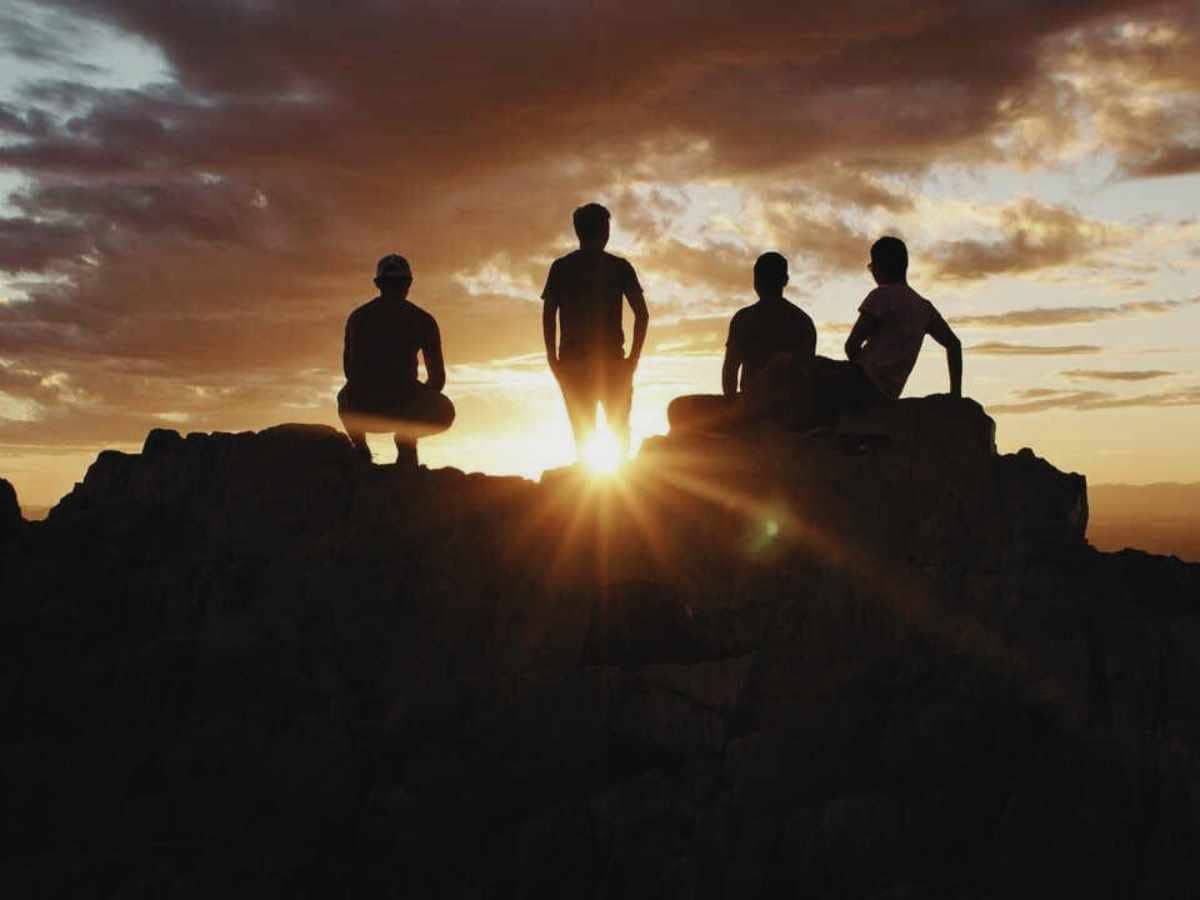 four tourists watch the sunset from a Wildlife Heritage Area for responsible travel