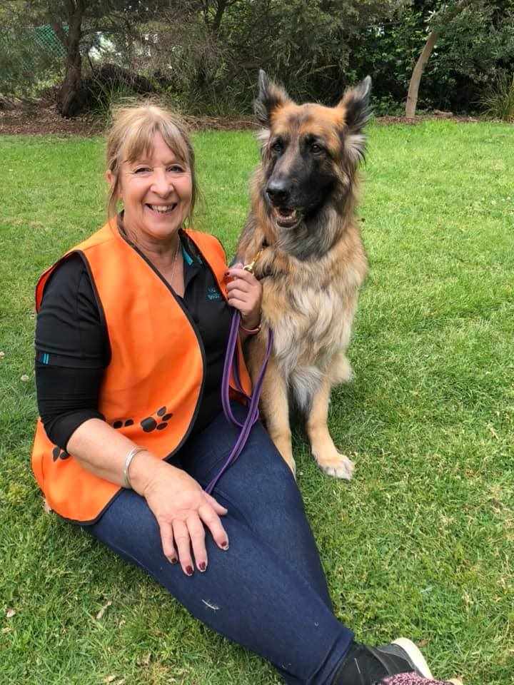 This year's Dog of the Year winner Kali sitting on grass with her owner Sharyn for Animal Friendly Life's winners and people's choice awards