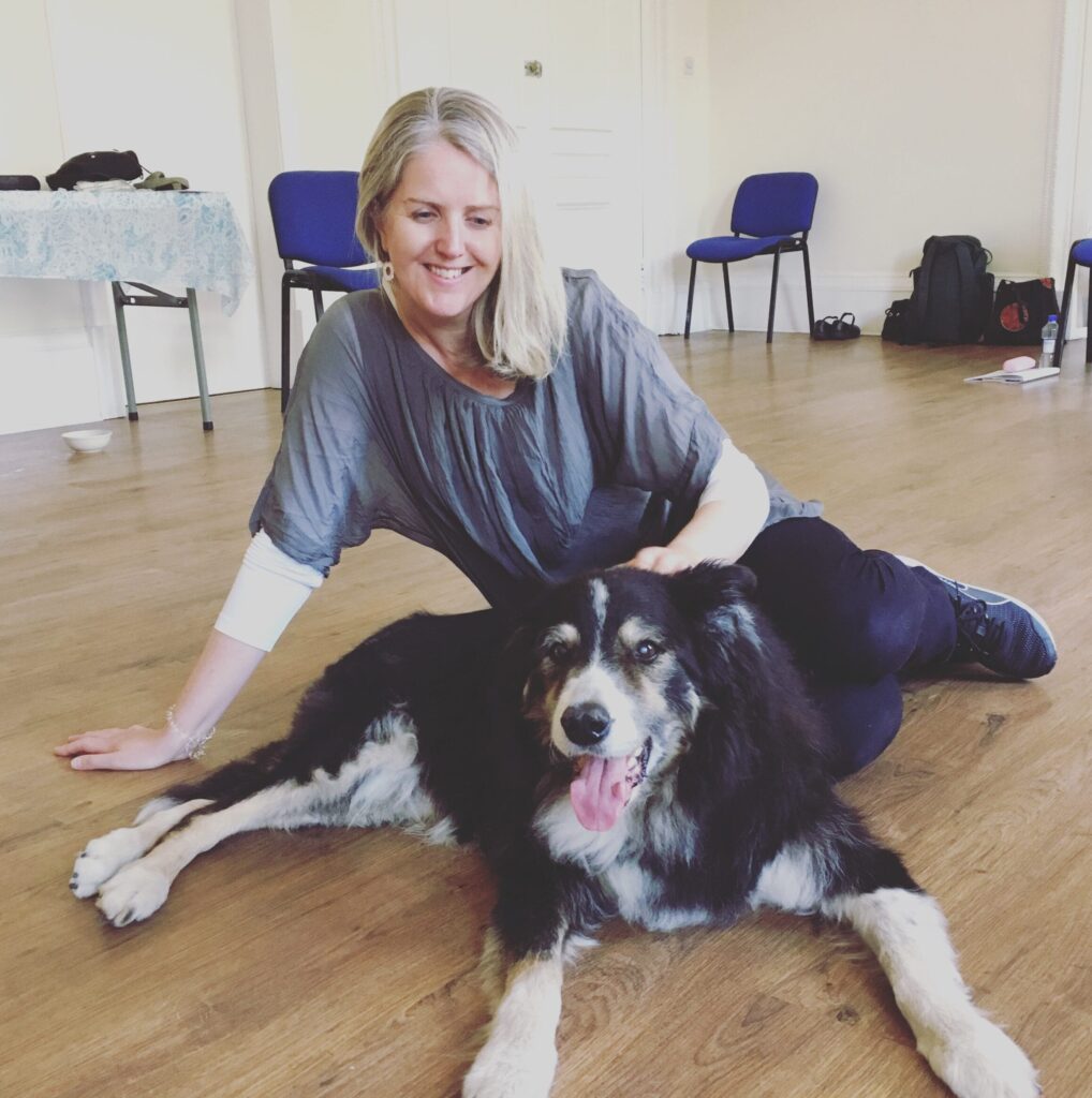 Animal communicator Pea Horsley sits with dog during animal telepathy