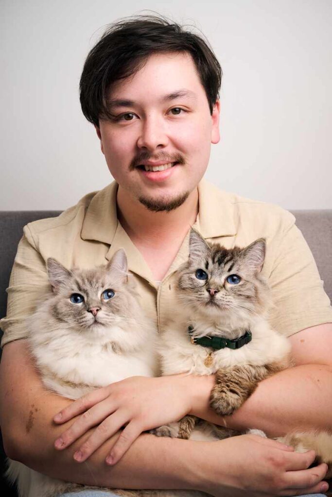 Owner Liam with rescue cats Zym and Rayla