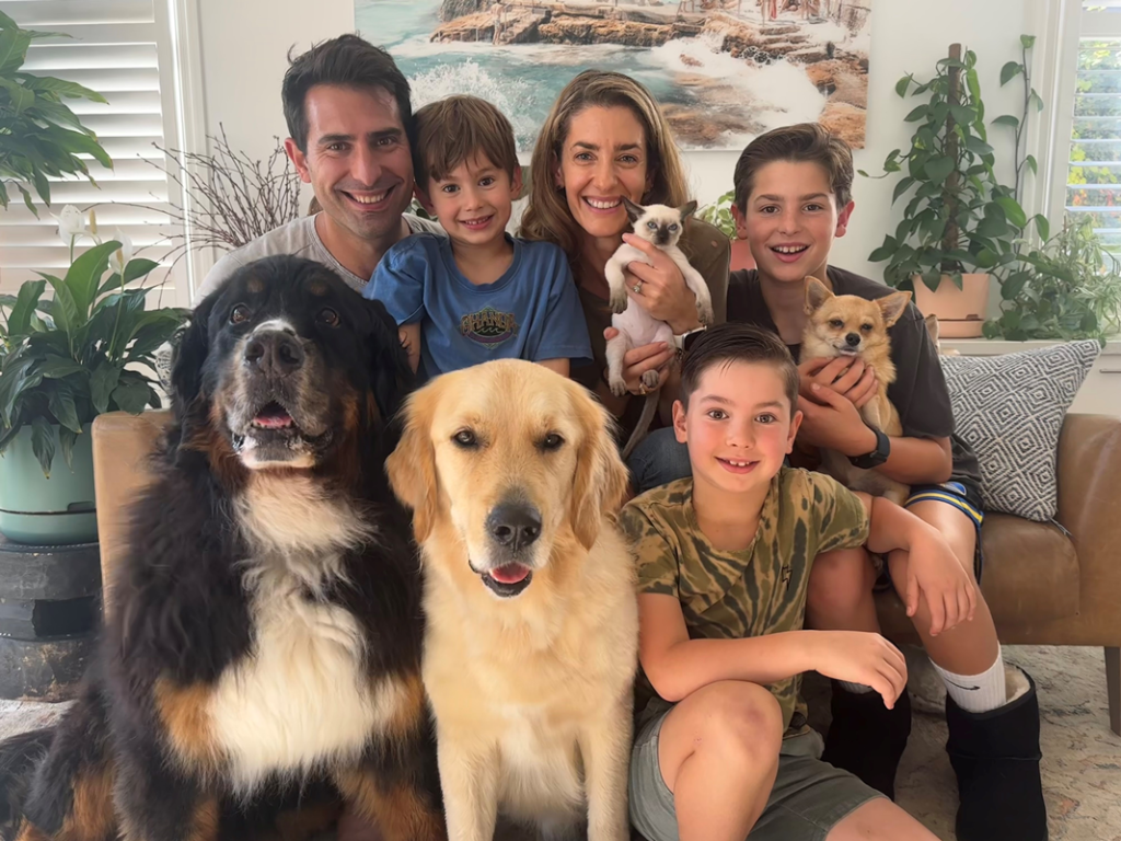 Lana Meltzer, owner of Golden Paws Dog Therapy, sits on couch with her family and pets for canine intestinal worms prevention