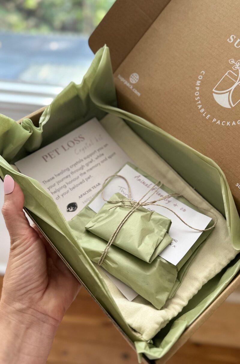 Hand holding a box of wrapped crystals for pet loss for product for memorials or gifts after pet loss