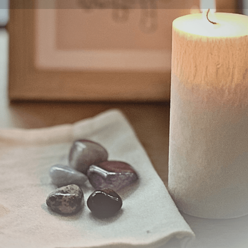 Healing crystals for pets next to candle for crystals for pet memorial